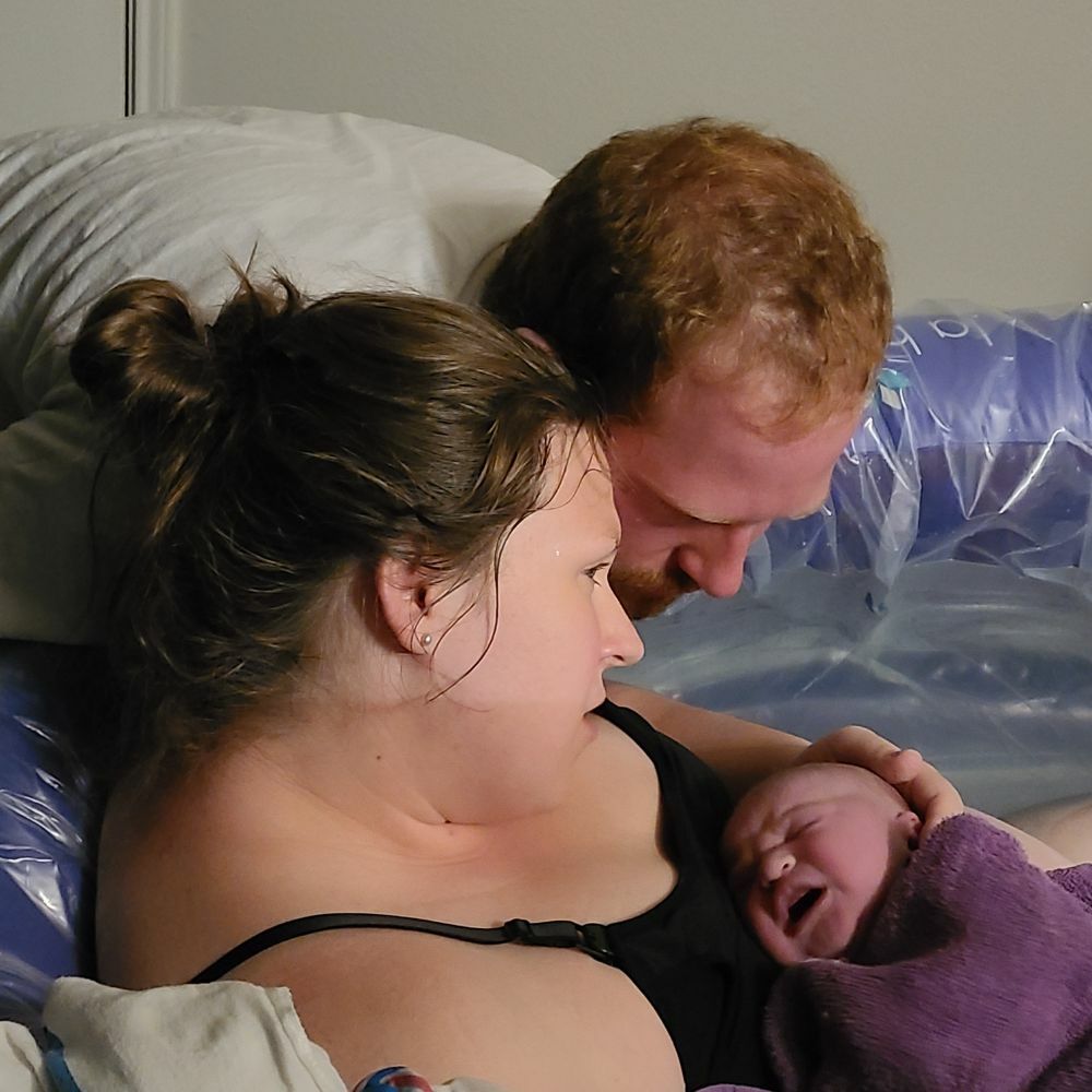 baby held by mother after birth